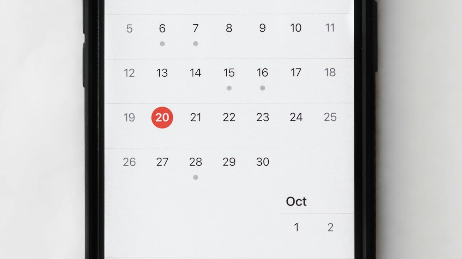 A phone with a calendar app on the screen.