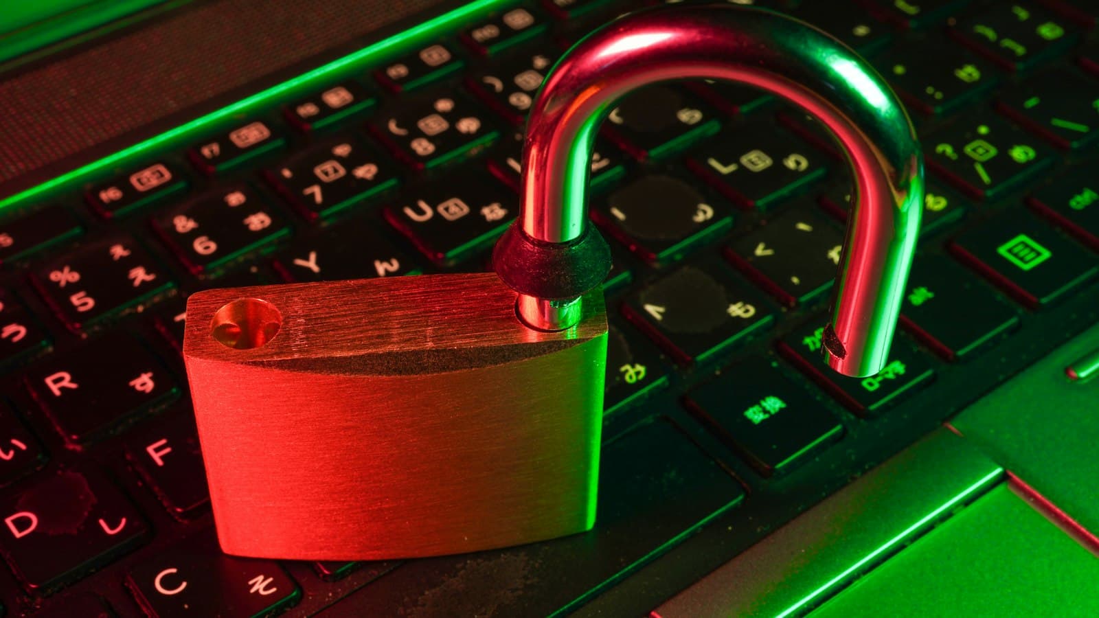 A red padlock on a black computer keyboard.