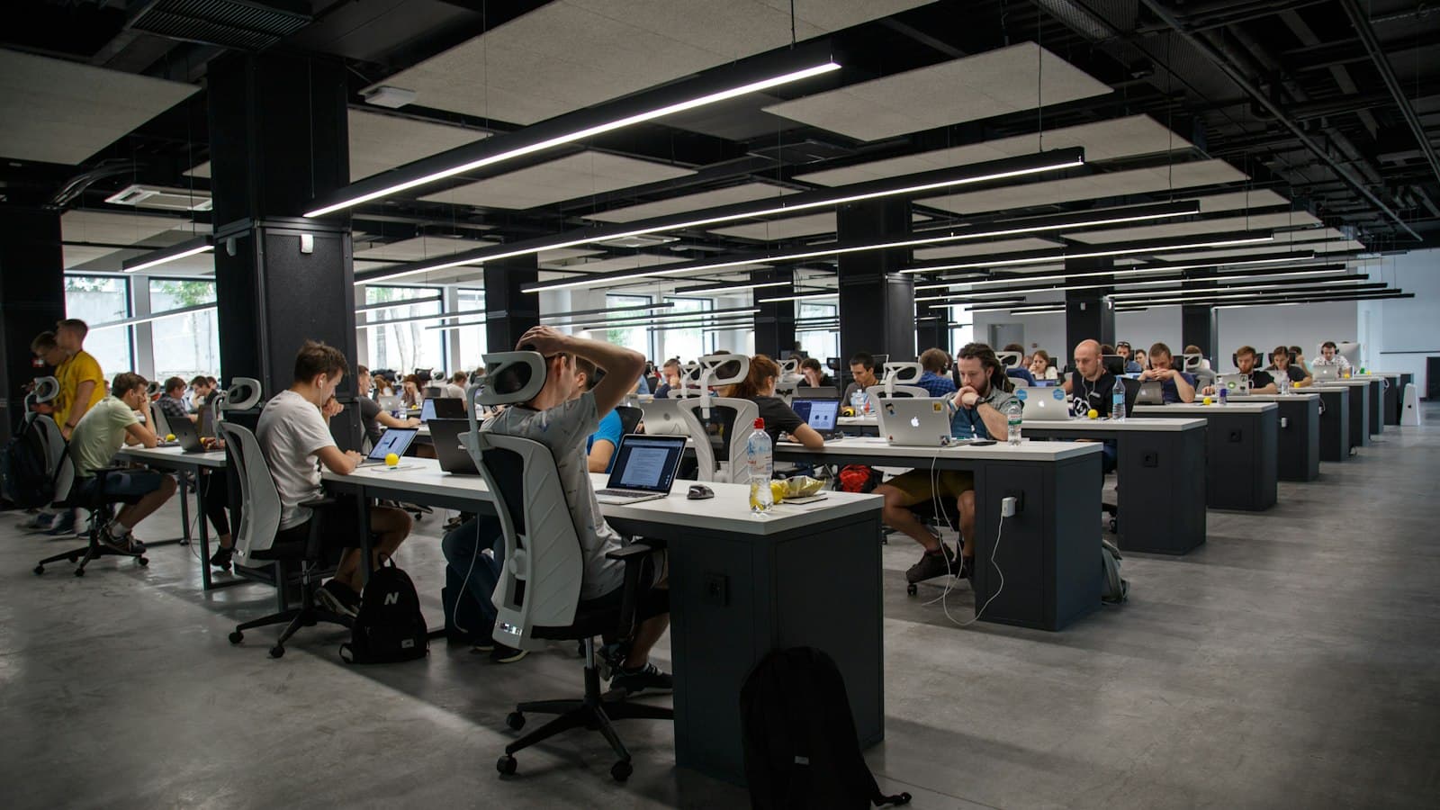 People working together at desks in an open office space.