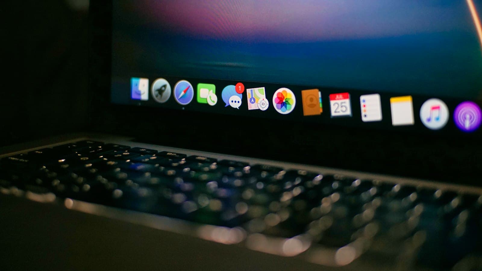 A close up of a laptop computer with app icons on the screen.